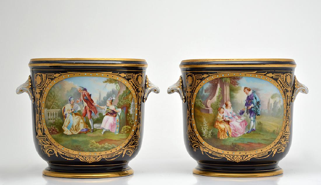 SEVRES: Pair of Sèvres porcelain pots decorated with romantic scenes and landscapes in medallions and golden nets. Marked on the bottom. 19th century. H: 23cm - 9" Provenance: Tailfer family collection