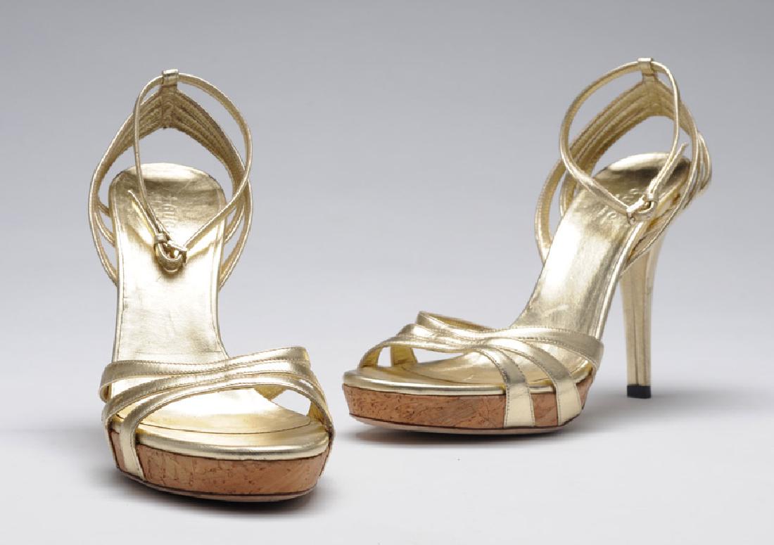 GUCCI: Gold leather sandals, high heels, ankle strap.