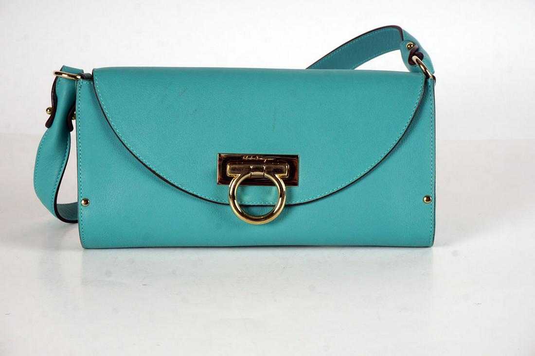 SALVATORE FERRAGAMO: SALAVORE FERRAGAMO BAGSmall smooth turquoise rectangular leather bag with flap with handle worn on the shoulder or across the body.Clasp and hardware in gilt metal. Gold-plated metal trim.26x13cm Fren