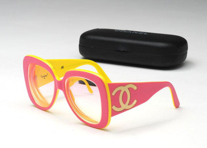 CHANEL: CHANEL Pink and yellow bicolor glasses decorated with the initials on the arms in their original case. Prescription lenses.