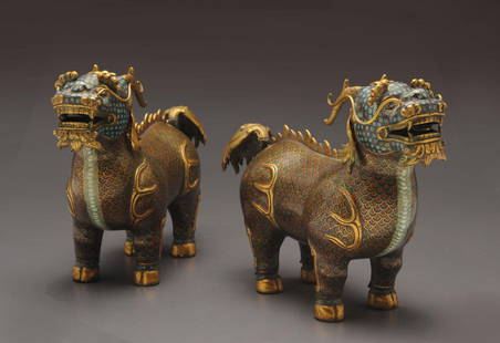 TWO CLOISONNE ENAMEL QILIN CHINA Each qilin is stro: TWO CLOISONNE ENAMEL QILIN CHINA Each qilin is strongly cast standing four-square on stout legs with gilt hooves and raised head; each animal has long gilt whiskers, horns, furry eyebrows and beard