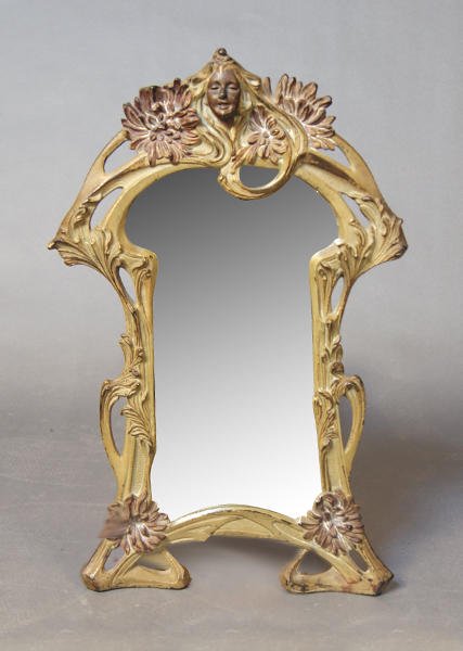 ART NOUVEAU: ART NOUVEAU mirror with metal frame, vegetating decor and female figure on the front. Old beveled glass. Height: 41cm - 16''