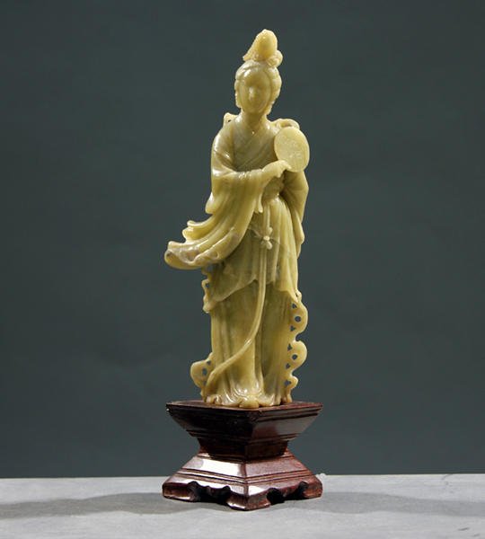 SOAPSTONE: A SOAPSTONE Guanyin hloding a mirror. China. Affixed on the basis. Height: 24cm - 9.5''