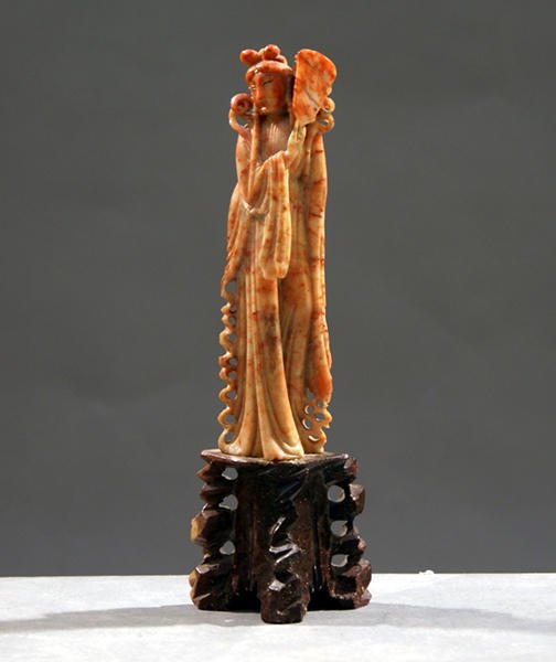 SOPASTONE: A SOAPSTONE Guanyin holding a mirror. China. Affixed on the basis. Height: 17cm - 6.75''