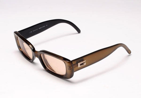 GUCCI: Pair of iridescent light brown glasses, monogrammed branches, in their original case. Prescription lenses.