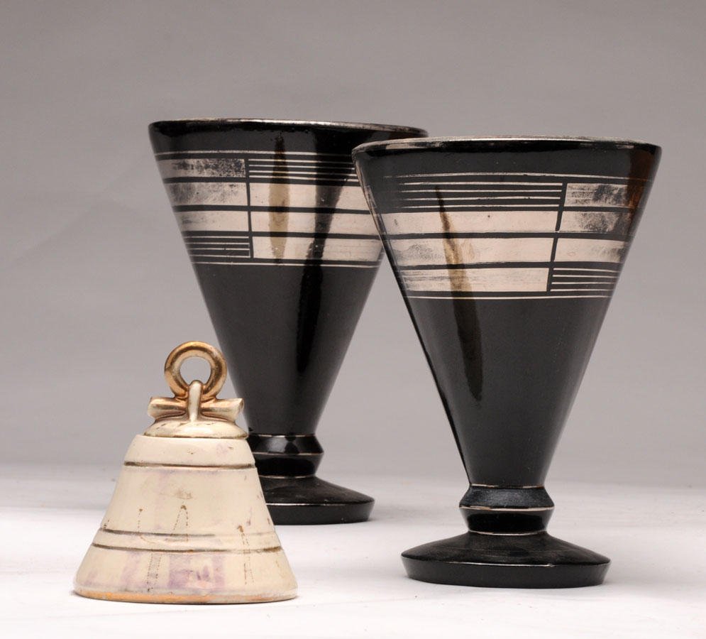 Lot comprising a pair of black and silver enameled: Lot comprising a pair of black and silver enameled lamps. Cylindrical flared shaped. Art Deco era. Hand signed on the bottom: Alsy, France. H:25,5cm-10 inches It also enclose a ceramic candy jar beige