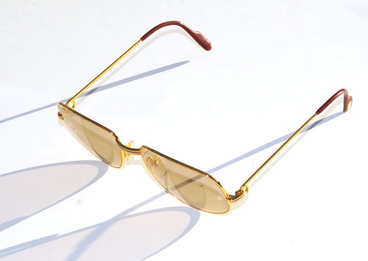 CARTIER Pair of gold tone sunglasses. Signed: Car: CARTIER Pair of gold tone sunglasses. Signed: Cartier.