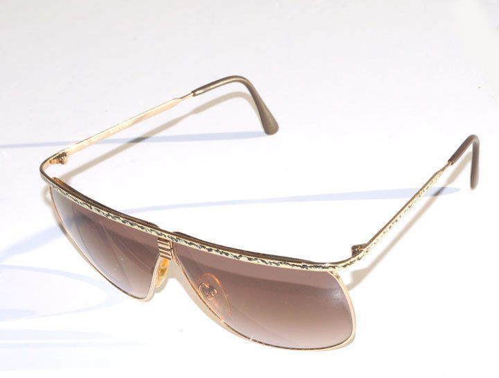 CARTIER Pair of gold tone and enamel sunglasses.: CARTIER Pair of gold tone and enamel sunglasses. Signed: Cartier.