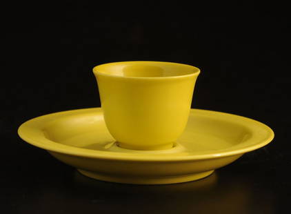 YELLOW-GLAZED PORCELAIN CUP AND SAUCER CHINA Qianlong s: YELLOW-GLAZED PORCELAIN CUP AND SAUCER CHINA Qianlong seal mark on the bottom. H (cup): 4cm – 1.75’’ D (saucer): 12.5cm – 4.75’’