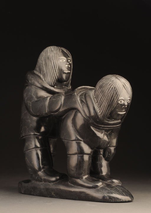 QUMALU TUKALA, Tamusi (1945-) Hunters Soapstone Signed: QUMALU TUKALA, Tamusi (1945-) Hunters Soapstone Signed and dated on the bottom: Thomassie Tookalook 75 "Igloo Tag" Certificate with the sculptor's name and his community: Inukjuak H: 27cm - 10.5" L: 2