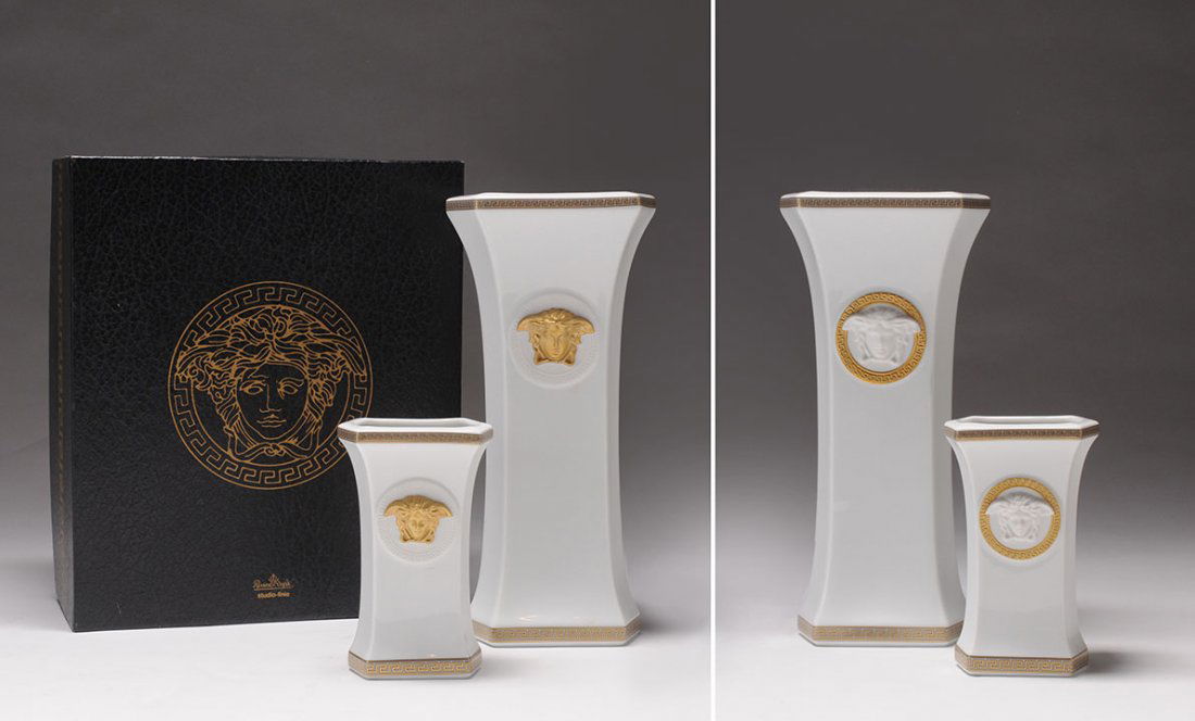 VERSACE - ROSENTHAL: Two Gorgona white porcelain vases decorated with gold tone twist friezes and medusa heads, white on one side and gold tone on the other side.