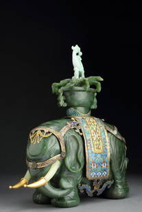 Antique Spinach Jade Elephant & Vase (Taiping Youpiang): ANTIQUE SPINACH-JADE ELEPHANT CHINA Standing four square in a solemn posture, a vase garnished with flowers and topped by a jadeite jade phoenix on its back, with a cloisonné en champlevé enamel sad