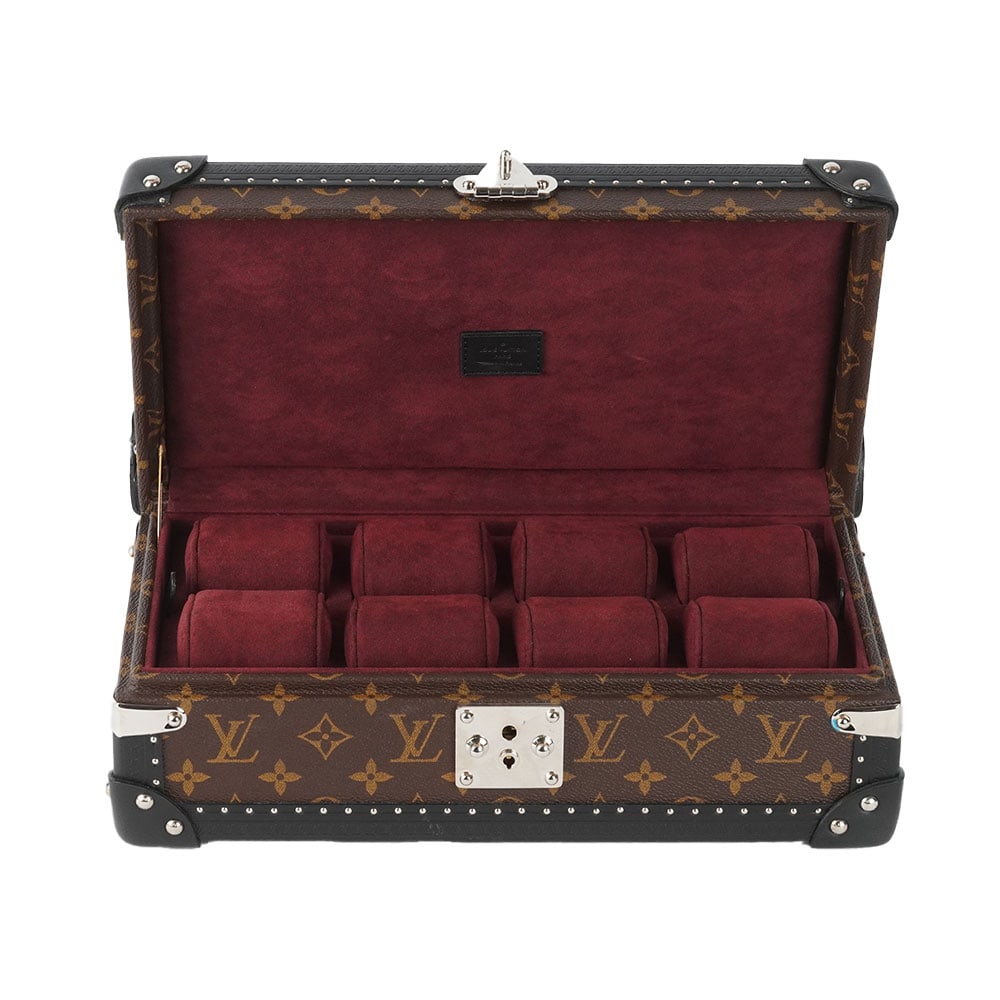 LOUIS VUITTON - MALLE À MONTRES / WATCH TRUNK: Description française: LOUIS VUITTON - MALLE À MONTRES Petite malle Louis Vuitton à 8 montres en toile Monogram et cuir noir, garniture en métal argenté, doublure en velours