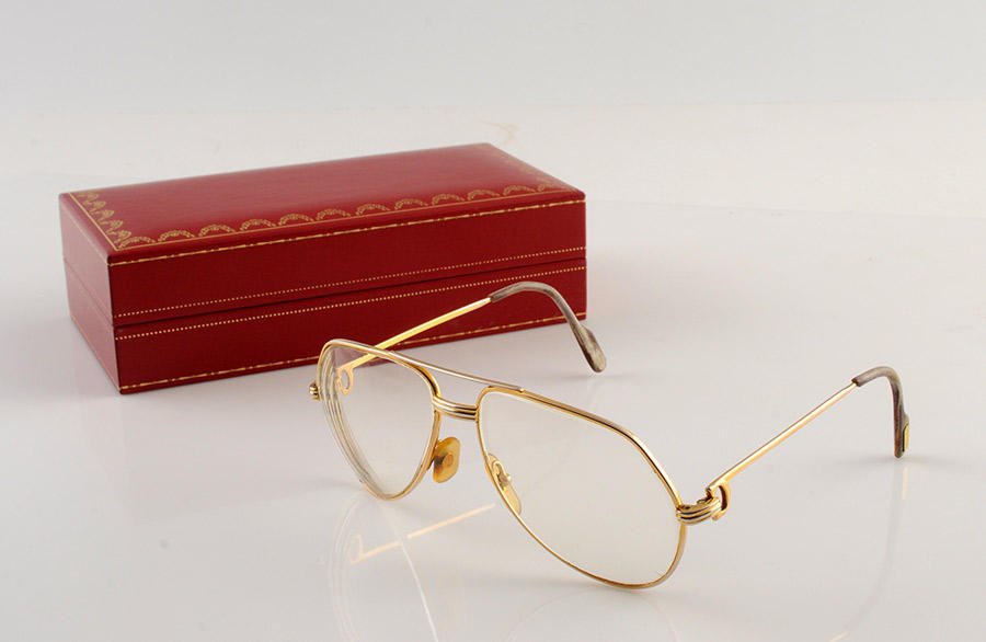 MUST DE CARTIER - MADE IN FRANCE: Goldplated eyeglasses, model "Santos", the branches are adorned with the "C". With original case.