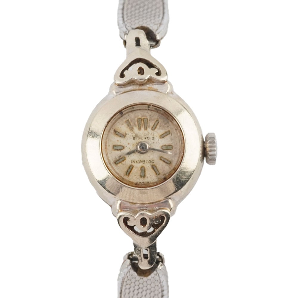MONTRE / WATCH: Description française: MONTRE / WATCH Montre de dame, boîtier en or blanc 14K de 18 mm, bracelet plaqué or. English Description: WATCH Ladies' watch, 18mm 14K white gold case,