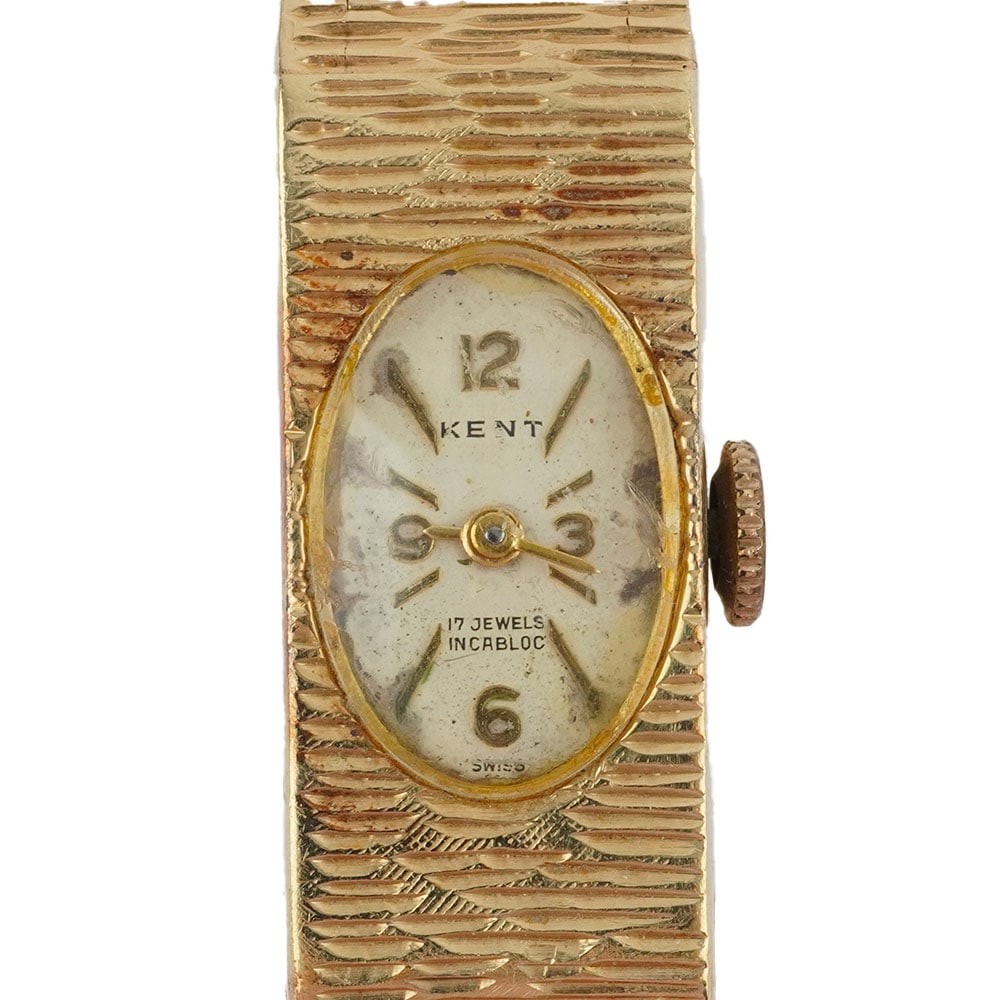 KENT: Description française: KENT Montre-bracelet Kent de dame en or jaune 14K, boîtier rectangulaire de 23.1 x 11 mm, cadran ovale, index mixtes appliqués pour les heures, mouvement
