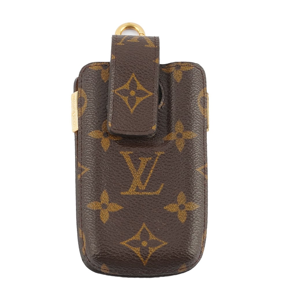 LOUIS VUITTON: Description française: LOUIS VUITTON Porte-téléphone Louis Vuitton en toile Monogrammé et cuir naturel. H: 14 cm - 5.5", L: 7.5 cm - 3" English Description: LOUIS VUITTON Louis Vui