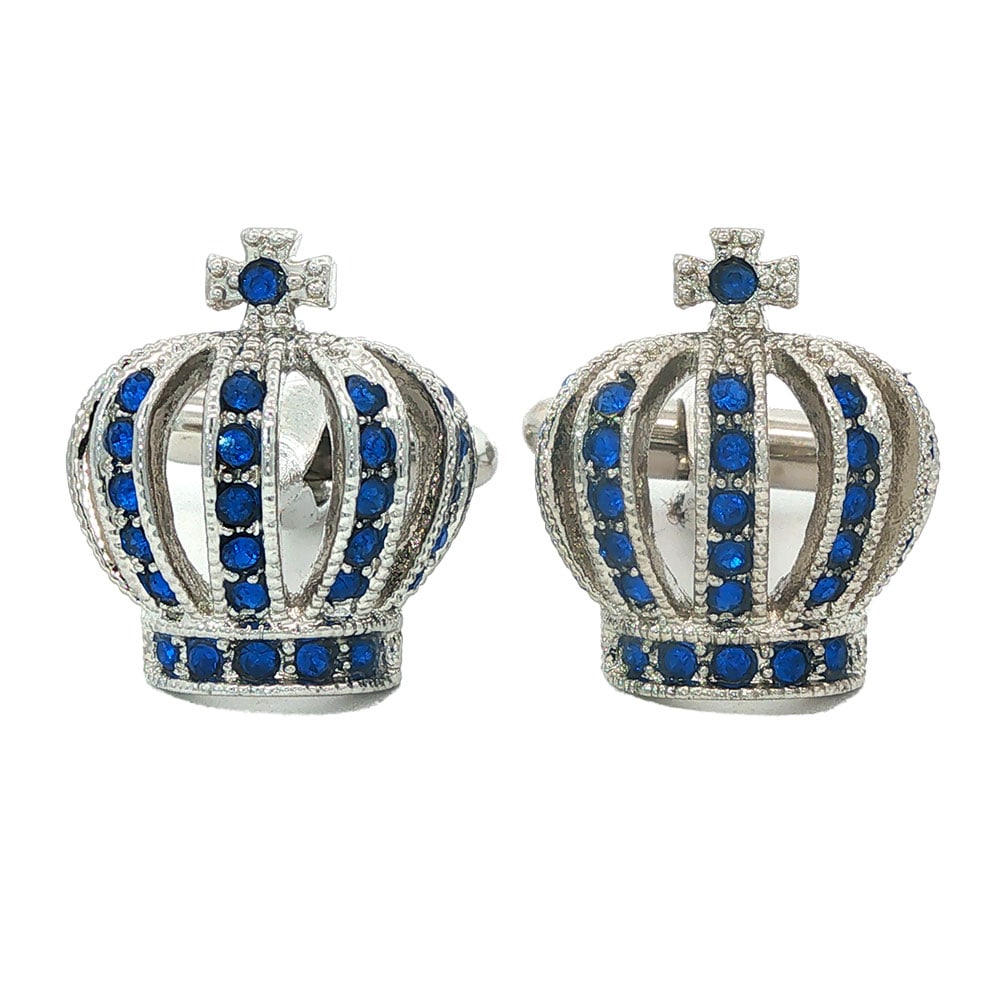 BOUTONS DE MANCHETTE/ CUFFLINKS: Description française: BOUTONS DE MANCHETTE Boutons de manchette en métal argenté représentant une couronne sertie de pierres bleues. English Description: CUFFLINKS Silver-tone