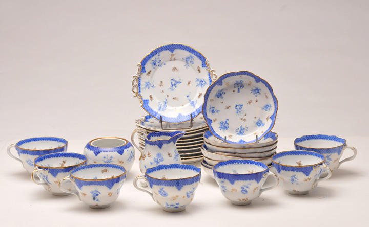 HENREND HUNGARY MORITZ FISCHER: A complete bone china broth service for six decorated with flowers and blue and gild scales including bowls, saucers and dessert plates. Herend, Hungary, Moritz Fischer, 1856. Also included : a milk j