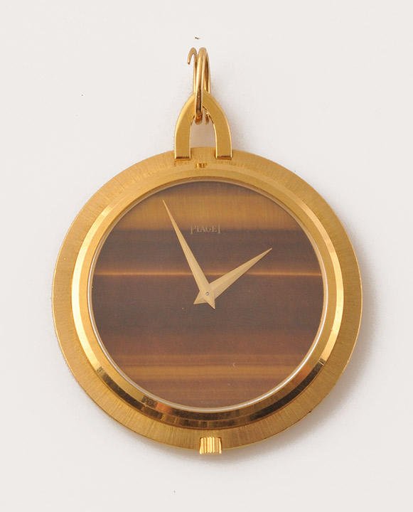 PIAGET - 18K GOLD, TIGER'S EYE: 18K yellow gold (stamped) pocket watch, tiger eye stone dial. Mechanical movement. Signed “Piaget”. Reported in Vogue magazine in the 1950’s. With its box. Madeleine Brillant Humbert collectio