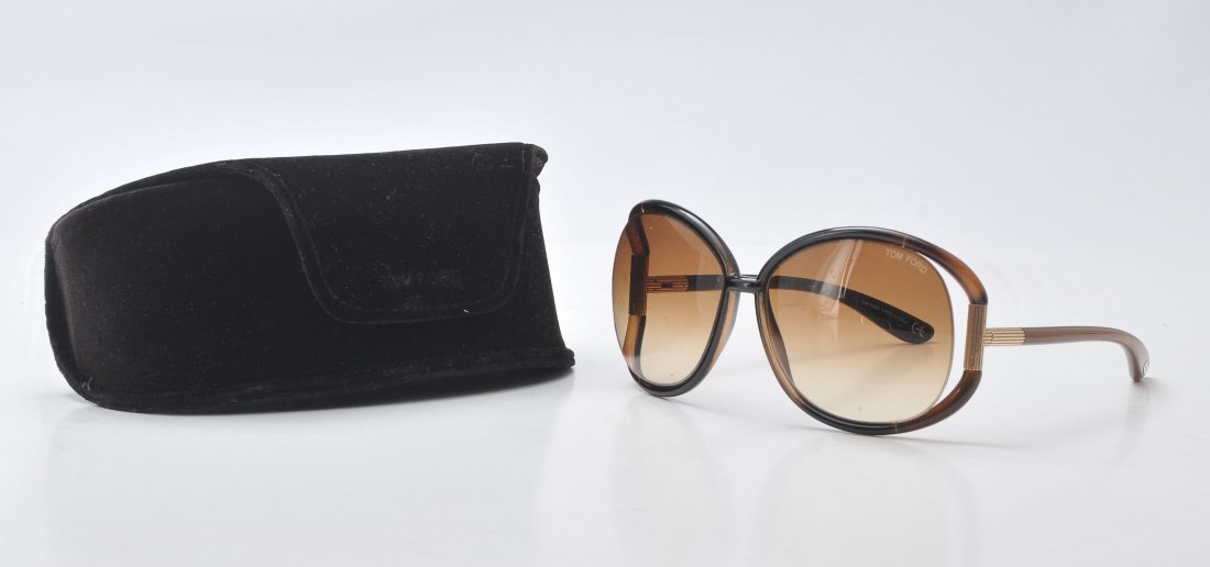 TOM FORD: Transparent brown sunglasses with gild details. In its original case.