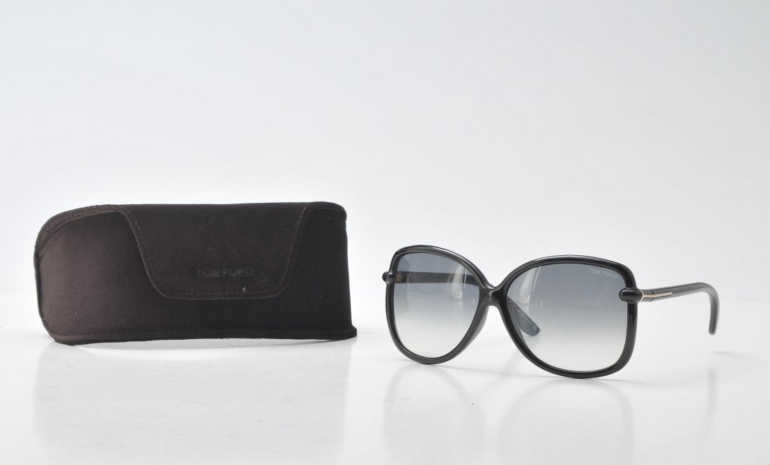 TOM FORD: Black sunglasses with silver details. In its original case.