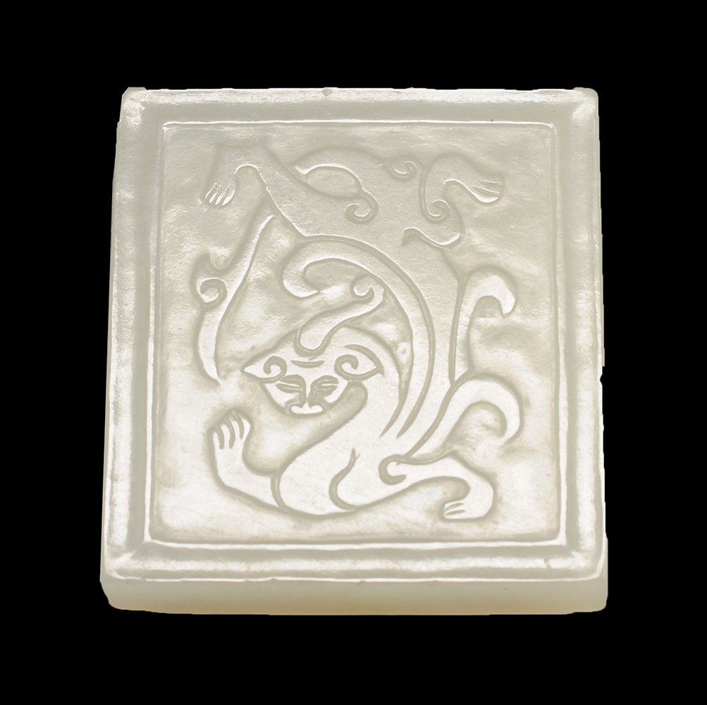 ANTIQUE CARVED WHITE JADE PENDANT: ANTIQUE CARVED WHITE MUTTON FAT JADE CHILONG PENDANT PLAQUE CHINA Of rectangular shape, the front carved in low-relief with a lively chilong, the back with two confronted masks on a lozenge pattern ba