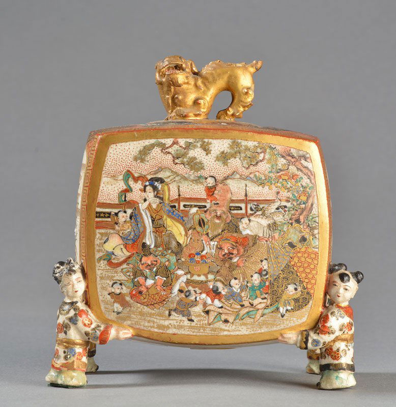 RECTANGULAR SATSUMA EARTHENWARE INCENSE BURNER: RECTANGULAR SATSUMA EARTHENWARE INCENSE BURNER with polychrome decor of medallions with children and gods of happiness. The feet are in the form of children. JAPAN. MEIJI Period (1868 - 1912). H: 11cm