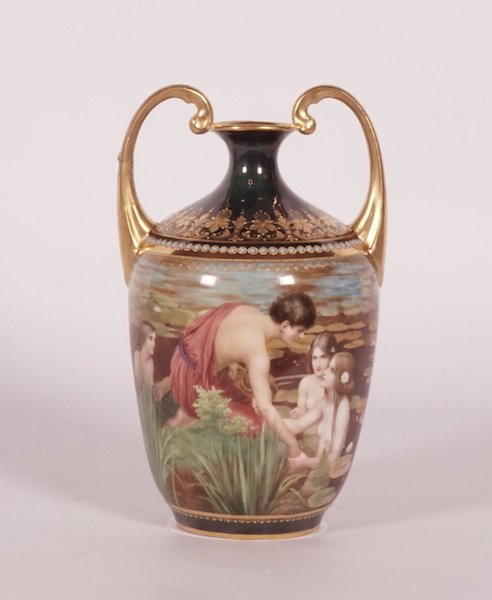 PORCELAINE: Amphora porcelain vase with polychromatic decorations representing a fisherman and mermaids, decorated with gilded garlands. Stamped in the bottom "Fischer und Nixen" H : 24.5cm - 9.5" L : 15cm - 6"