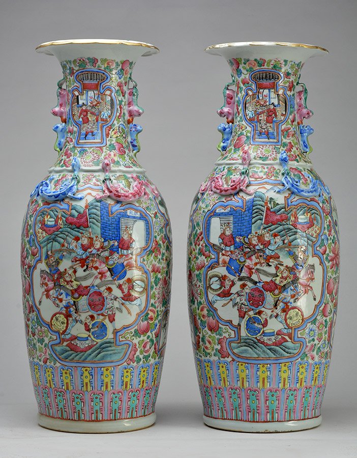 CANTON - LATE 19th C.: Pair of Cantonese polychromed porcelain vases decorated with traditional scenes, one tiger, birds and raised dragons. Handles in the shape of Fu dogs. Late 19th C.H: 63.5cm - 25''