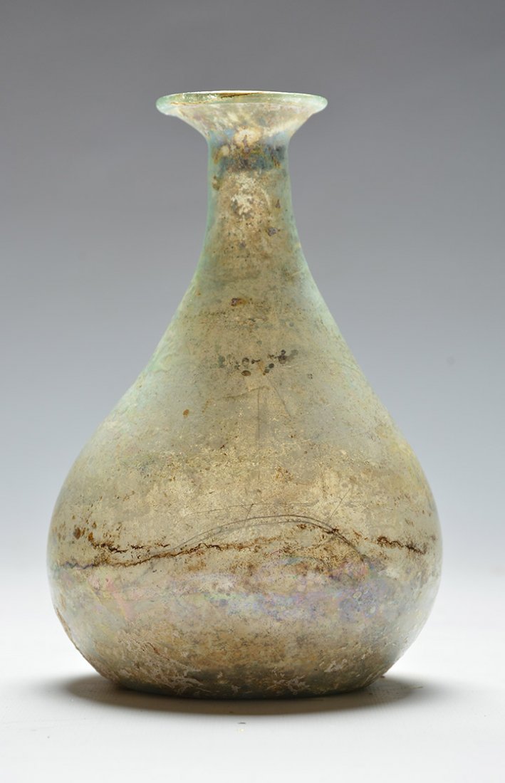 ROMAN - 1st-3rd Century A.D.: Roman, 1st-3rd Century A.D. Roman glass flask, rounded body with raised neck. H: 13.50 cm - 5.25" Provenance : Montreal estate, collection made in the 80s.