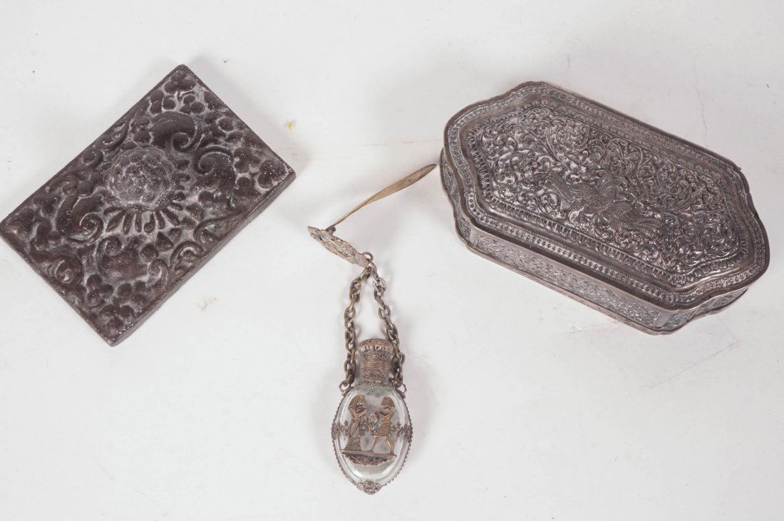 SILVER METAL: Set of 3 silver metal objet:-box decorated with scrollwork, shells, flowers and two peacocks with their necks entwined-a small bottle swoon decorated with egyptian figures -a metal and felt clipboard