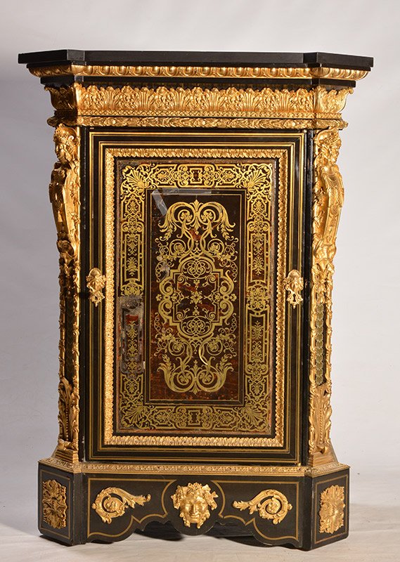 NAPOLÉON III PERIOD: Wood lacquered meuble d'apparat, with ebony style cut panels, opening by a lavishly inlaid door, with brass foliage on trompe l'oeil tortoisescales interlacing in the manner of Charles André Boulle a