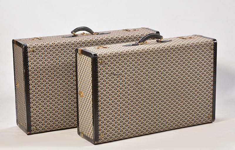 GOYARD - VINTAGE: GOYARD – VINTAGE Two Goyard woven canvas rigid suitcases of chevron pattern. Black leather angles and handles. Gilded brass fasteners. The largest measures : 23x 85x52cm – 9x33.50x20.50’’