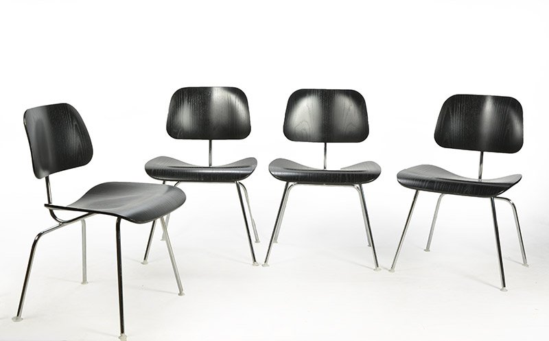 EAMES, Charles (1907–1978) & Ray (1912–1988): EAMES, Charles (1907–1978) & Ray (1912–1988) Series of four DCM chair, the backrest and seat made in black lacquered wood, the structure made in chromed metal. Herman Miller Edition. 76x49.5x47c