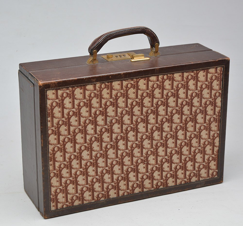 CHRISTIAN DIOR: CHRISTIAN DIORMonogram fabric and brown leather travel case, gilt metal trim, combination lock. Brown velvet inside with compartiments. H: 23.5cm- 9.15"L: 34.5cm - 13.5"W: 12cm - 4.75"
