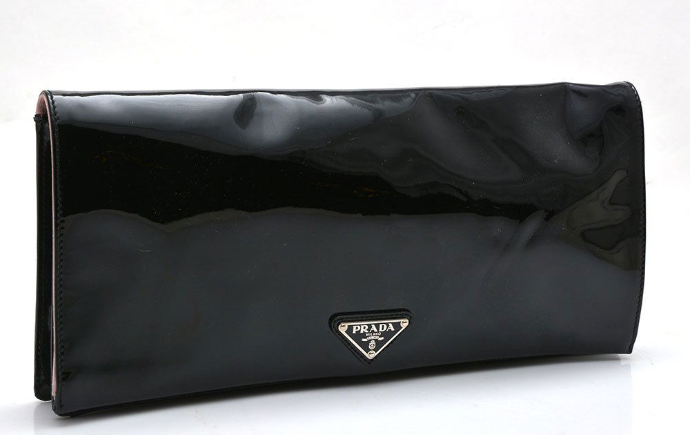 PRADA MILANO - MADE IN ITALY: PRADA MILANO - MADE IN ITALY Black patent-leather night clutch adorned with the logo on the lower centre, powder pink satin interior with signed pocket mirror and a small pocket, magnetic snap closure