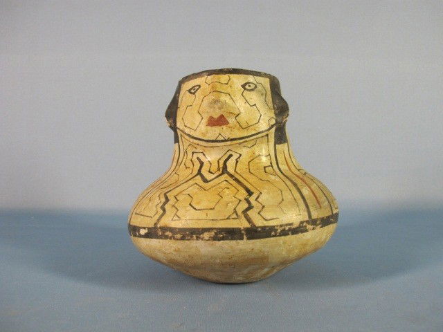 Shipibo Polychrome Earthenware Face Jar: Shipibo - Conibo, Peru, Amazon aera. Small polychrome face jar (Joni Chomo). The neck with a low relief face and body of jar covered with a fine angular network of lines. Circa 1960. Condition: small