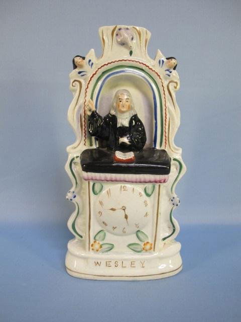 Staffordshire Rev. John Wesley in Pulpit, 19th c.: A Staffordshire Pottery figure of Reverend John Wesley in the Pulpit, midle19th century. The preacher standing with right hand raised in an arched pulpit with cherubim, an open bible in front over a c