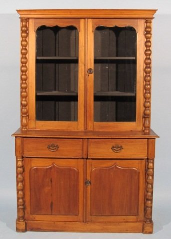 19c Stained Pine China Cabinet: Stained pine china cabinet, circa 1860-80, possibly of Texas origin, step-back design, with cavetto molded cornice, the 2 glazed upper doors with scalloped top design, the cabinet base having 2 short 