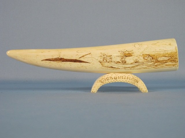 Walrus Tusk Scrimshaw: Russian Eskimo (Yupik) Walrus Tusk Scrimshaw, engraved on both sides on a stand; stand engraved Chukotka on one side and Egvekinot on the other, middle 1900's, L 8 1/2".