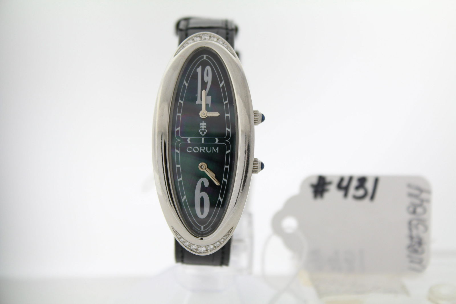 CORUM - LADIES - CORUM BLACK LEATHER STRAP WITH: CORUM - LADIES - CORUM BLACK LEATHER STRAP WITH ADJUSTABLE TANG BUCKLE - STAINLESS STEEL CASE 25mm x 52mm WITH DIAMONDS AT 12 & 6 SPOTS - TAHITIAN MOTHER OF PEARL DIAL WITH INDEX MARKERS / TWO TIME ZO