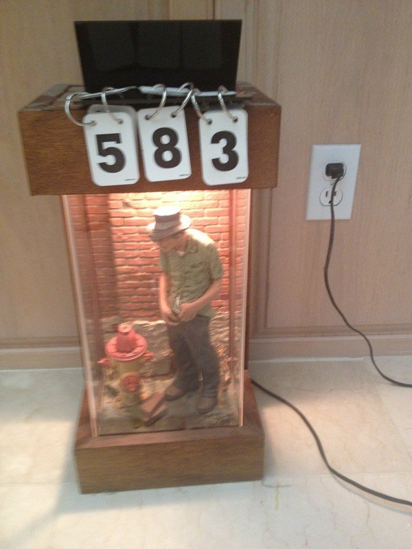 DISPLAY CASE FEATURING MAN & FIRE HYDRANT - SIGNED: DISPLAY CASE FEATURING MAN & FIRE HYDRANT - SIGNED MICHAEL GARMAN 1978 - WITH LIGHTING