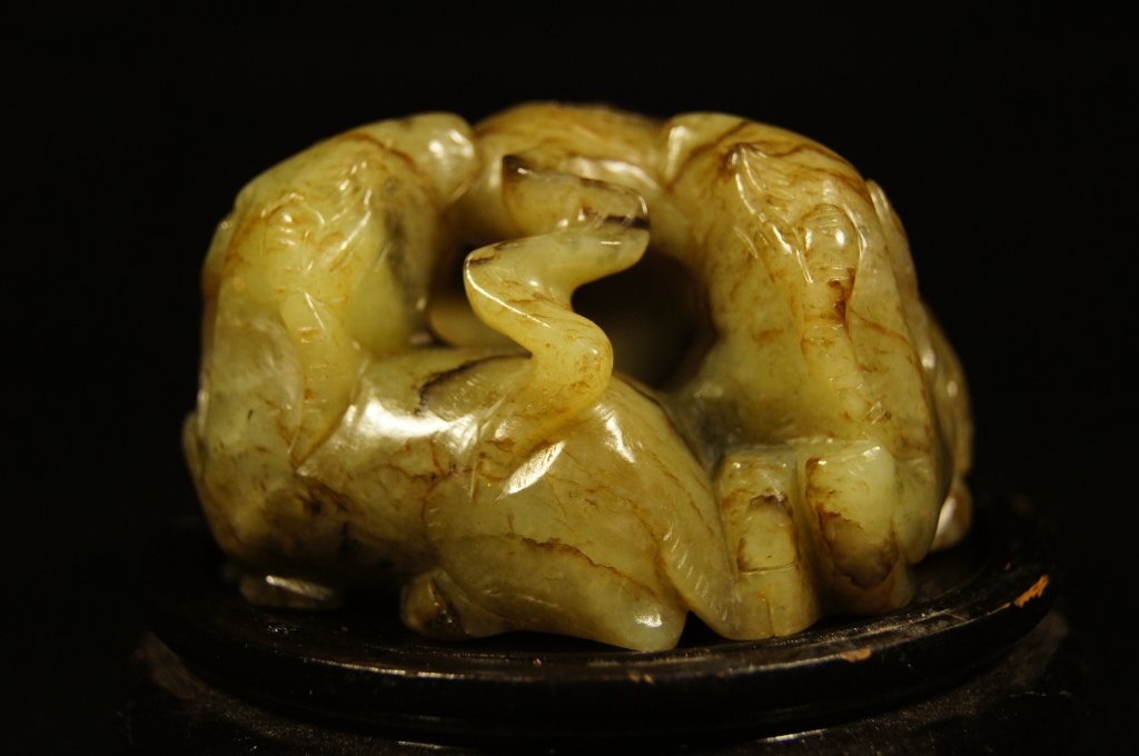 Chinese antique jade carving, 19th C: Chinese jade carving, finely carved as group of three rams, representing the rebus, "san yang kai tai" (three rams portend a bright future); the stone of greenish-white tone with russet markings, 19th