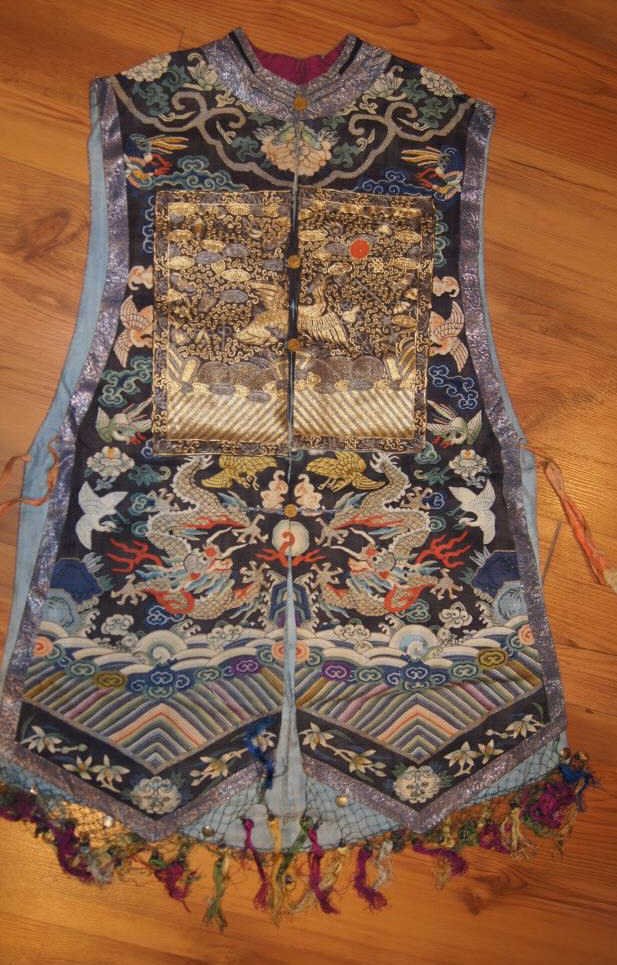 20th C Elaborate Chinese Lady's Embroidered Overve: 20th C Elaborate Chinese Lady's Embroidered Overvest First quarter 20th century, the sleeveless vest with rank badges on front and reverse, the front opening with silk fasteners, the black ground embr