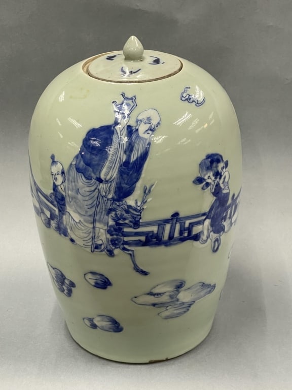 A Celadon Glazed Blue And White Jar And Cover: Height: 33cm.