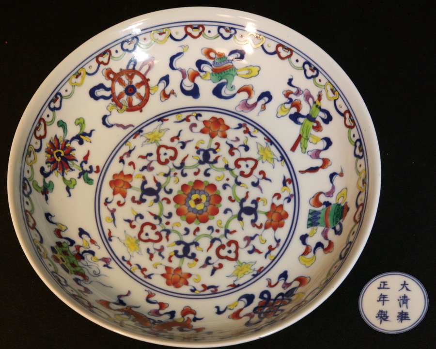 A Fine Doucai Plate: Decorated on the interior with a central medallion of lotus floral sprays, surrounded by eight Buddhist symbols, the exterior with same lotus sprays, Yongzheng six-character mark, Republic period. Dia