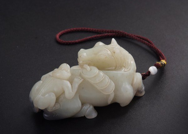 Well-carved Jade Horse and Monkey Group: Carved in the form a recumbent horse with a monkey climbing on its back , carrying a roll of cash coins, all depicting lucky symbols for success and rich. The jade stone with even white color. Qing Dy