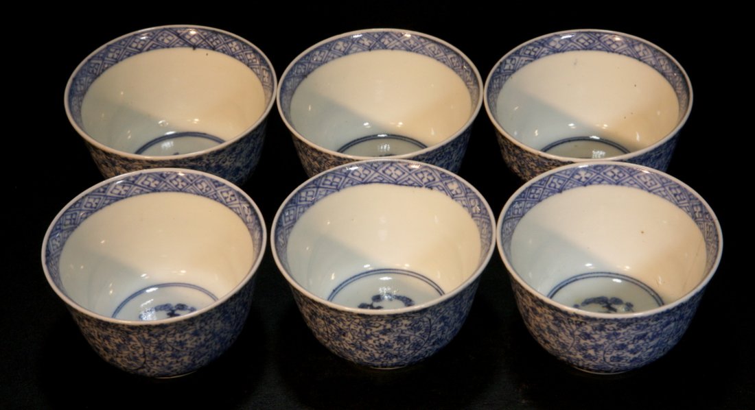A Set of Six Blue and White Cups: Each painted with an underglazed blue flower in the center, the exterior has the same floral sprays all over the body. 19th century. Diameter: 3", Height: 2"