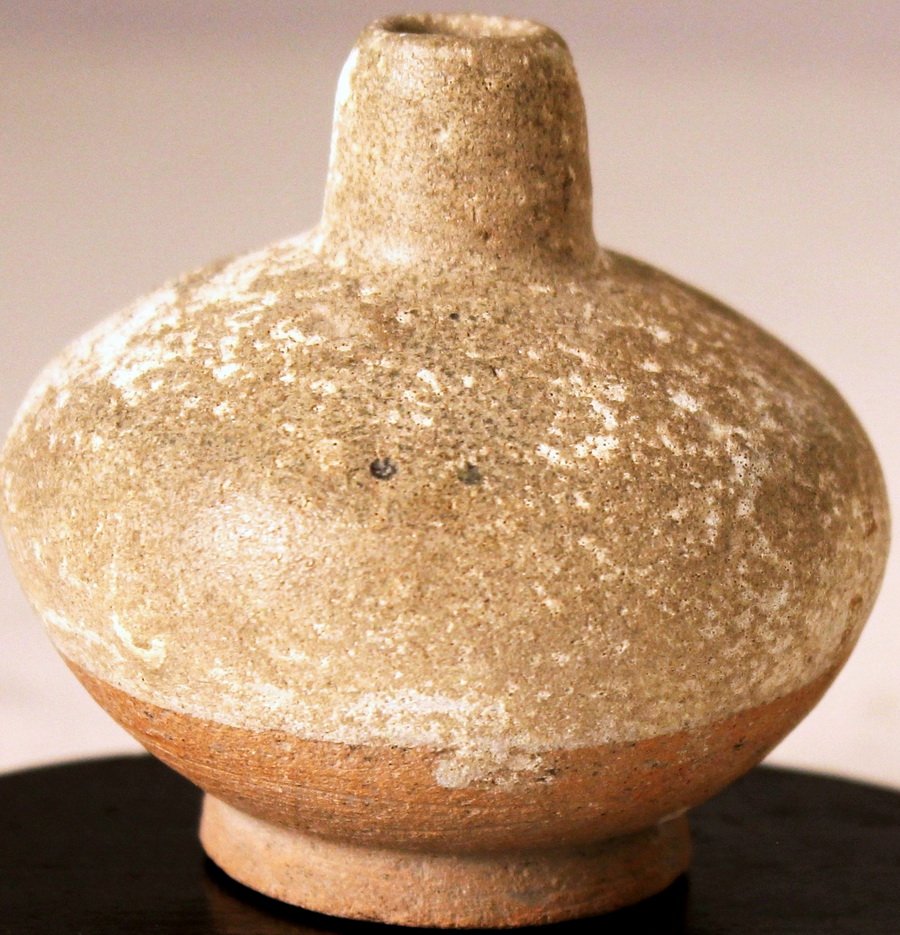 A Small Neolithic Pottery Jar: The upper body covered with buff colored glaze, the rest of gray pottery body. Han Dynasty. Diameter:3.5, Height: 2.5